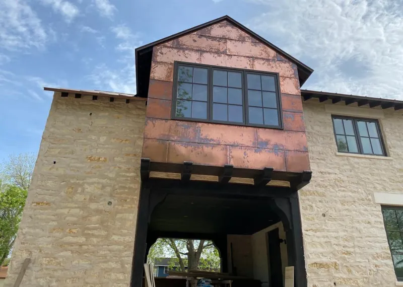 Copper metal panel facade on a stone building for Metal Roof Coating in Odessa